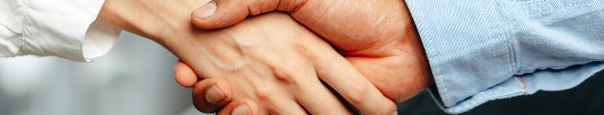 Female and male businesspeople handshake close up