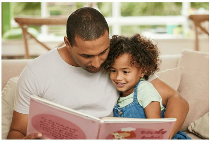 dad and daughter reading a book