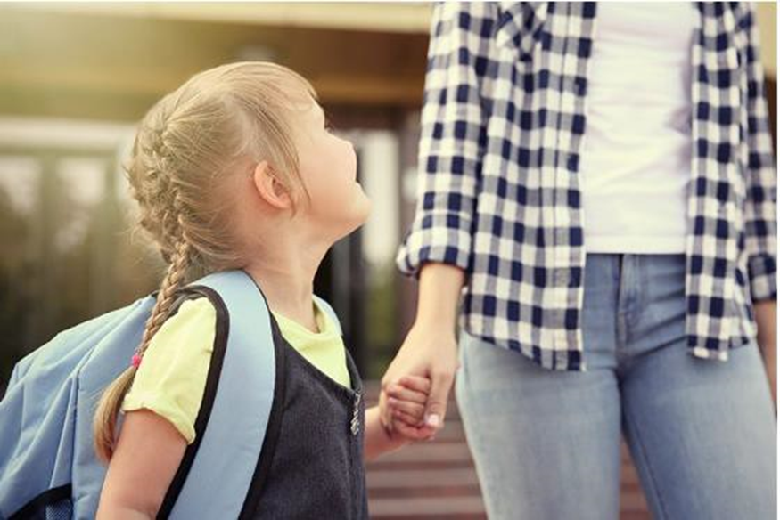 mom holding her daughter's hand as they walk
