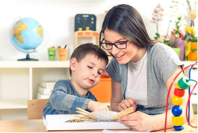Woman helping boy with school project