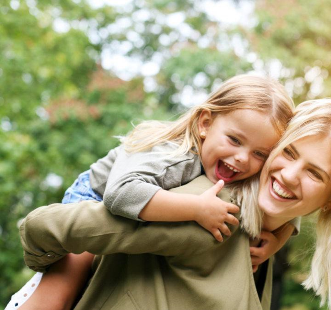 mom carrying daughter on her back