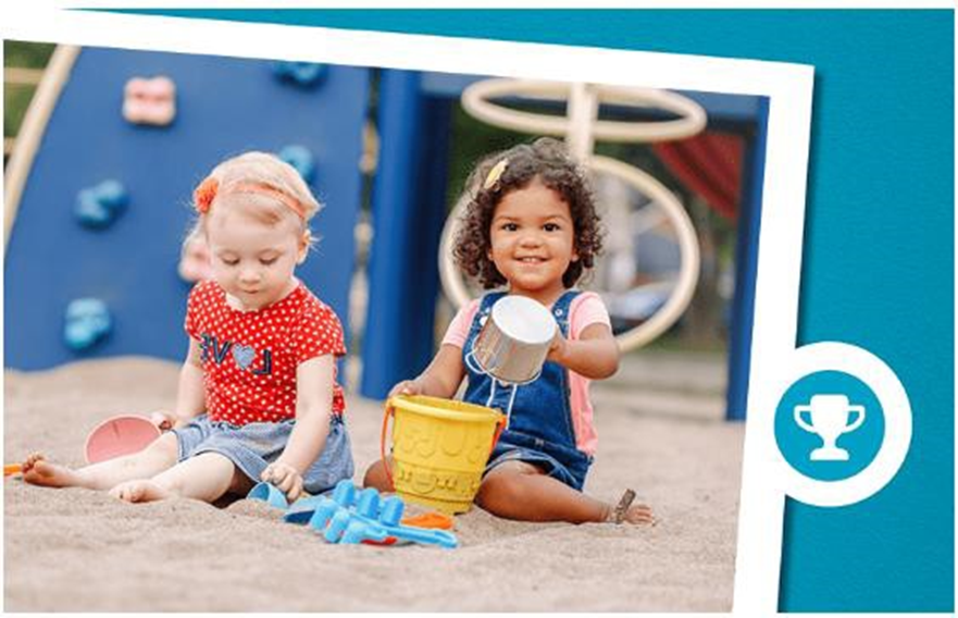 two girls playing in the sand with buckets