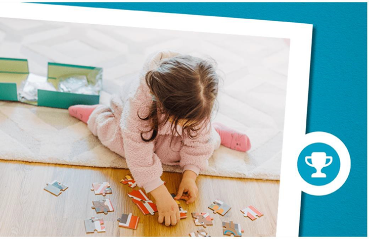 girl putting together puzzle pieces