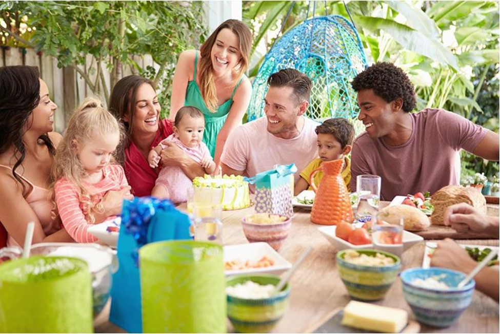 big family enjoying each other's company at an outdoor dining table