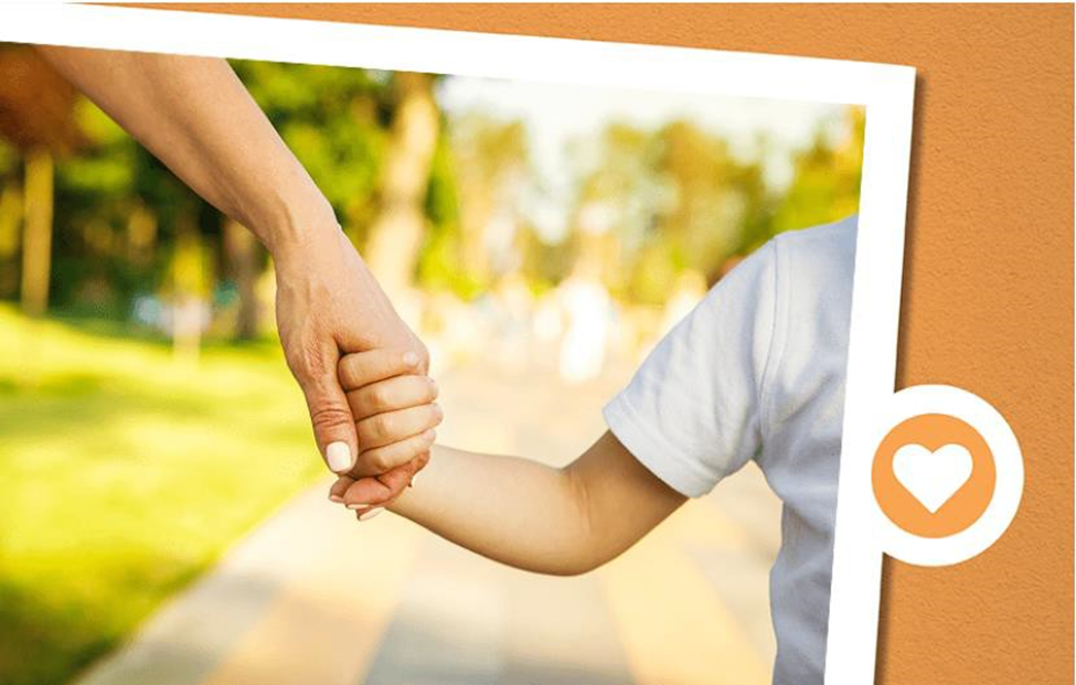 parent holding a child's hand as they walk together
