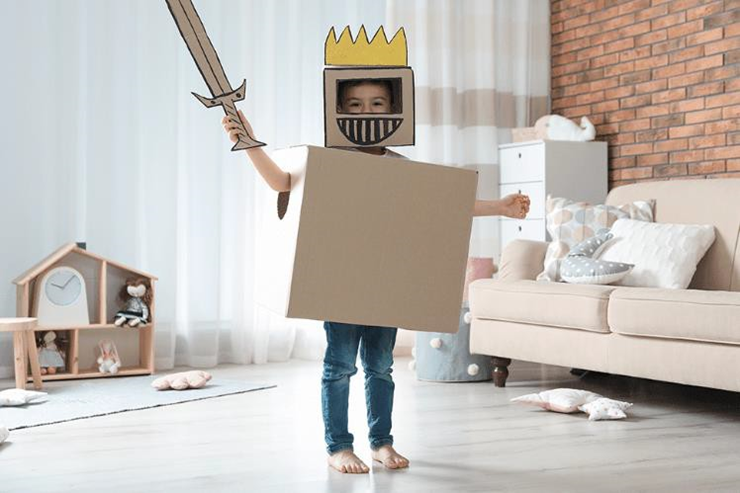 boy wearing a cardboard knight costume