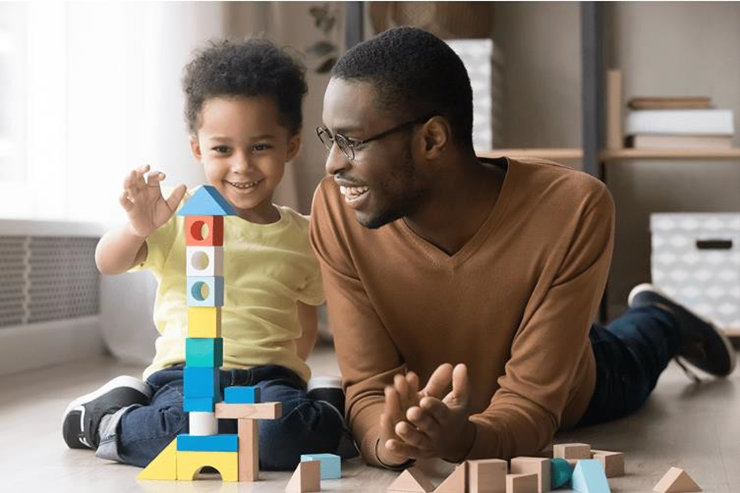 dad and child playing toy blocks