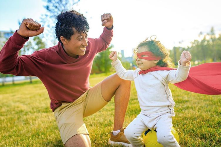 dad and child playing in the field