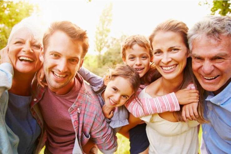 2 sets of parents and their kids smiling for the camera