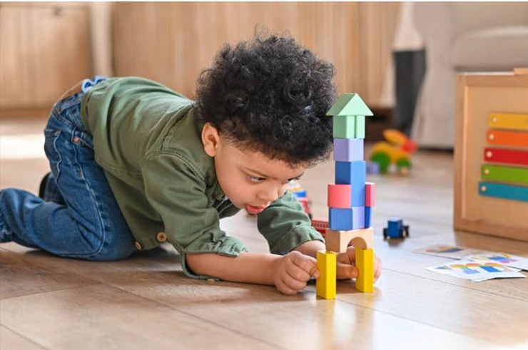 boy playing with toy blocks