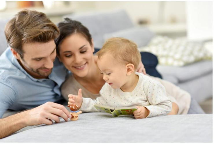 mom and dad playing with their baby